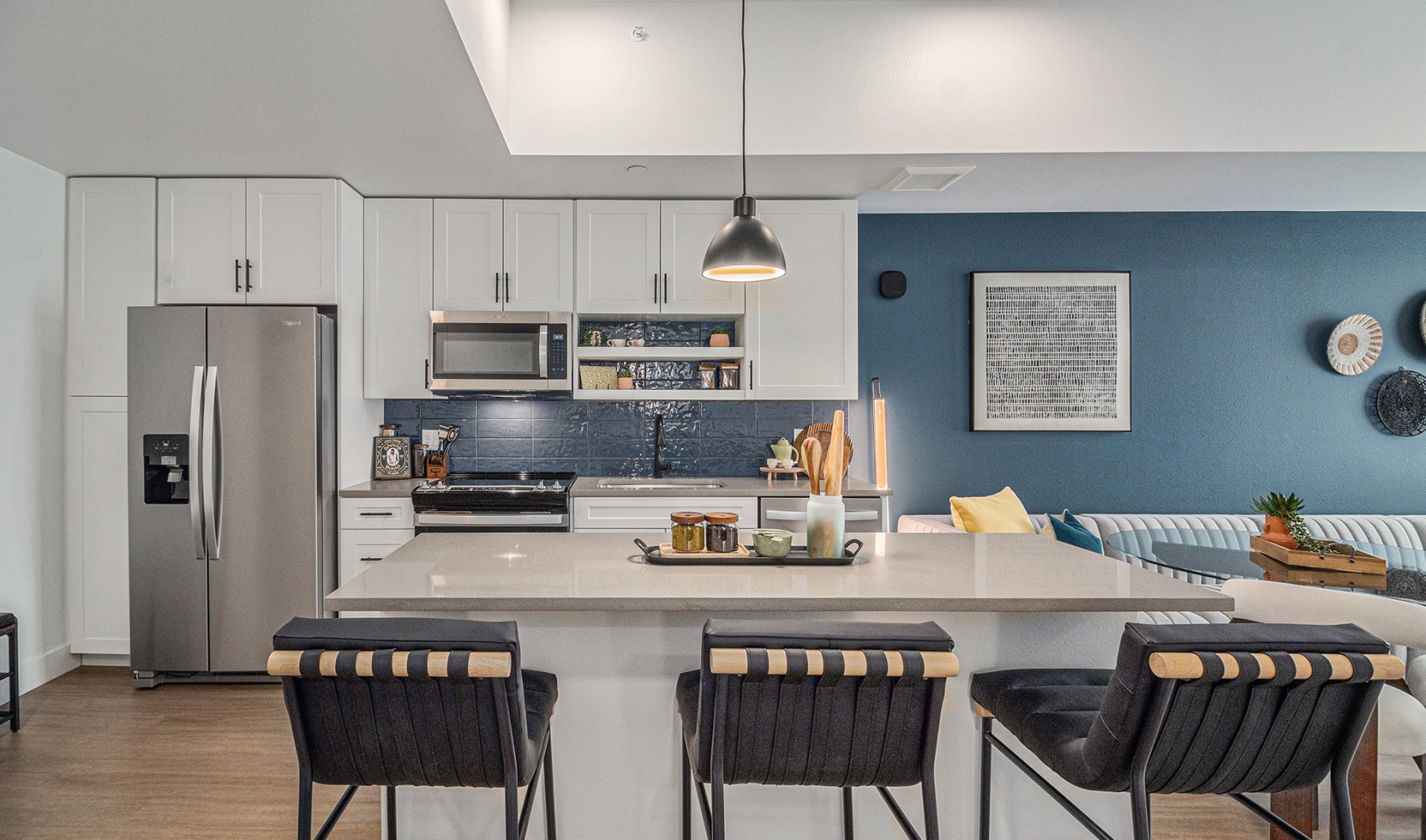 Cozy kitchen with quartz countertop and stainless steel appliances at The Riv apartments in RiNo, Denver