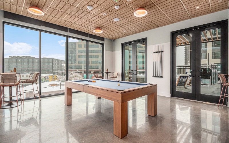 Clubhouse with billiards table at The Riv apartments in Denver, CO