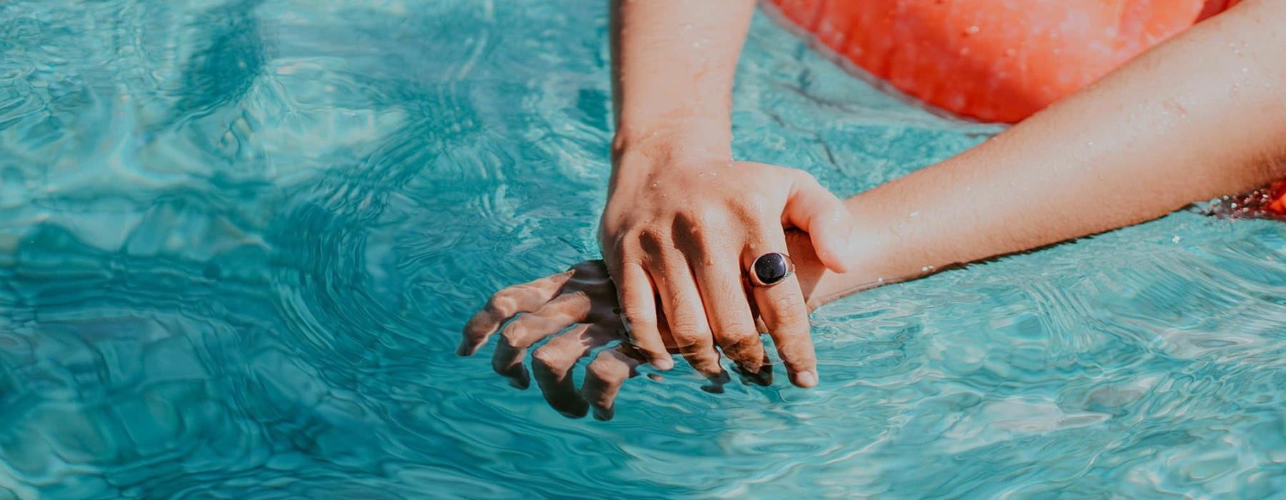 woman relaxes on a floatie in swimming pool